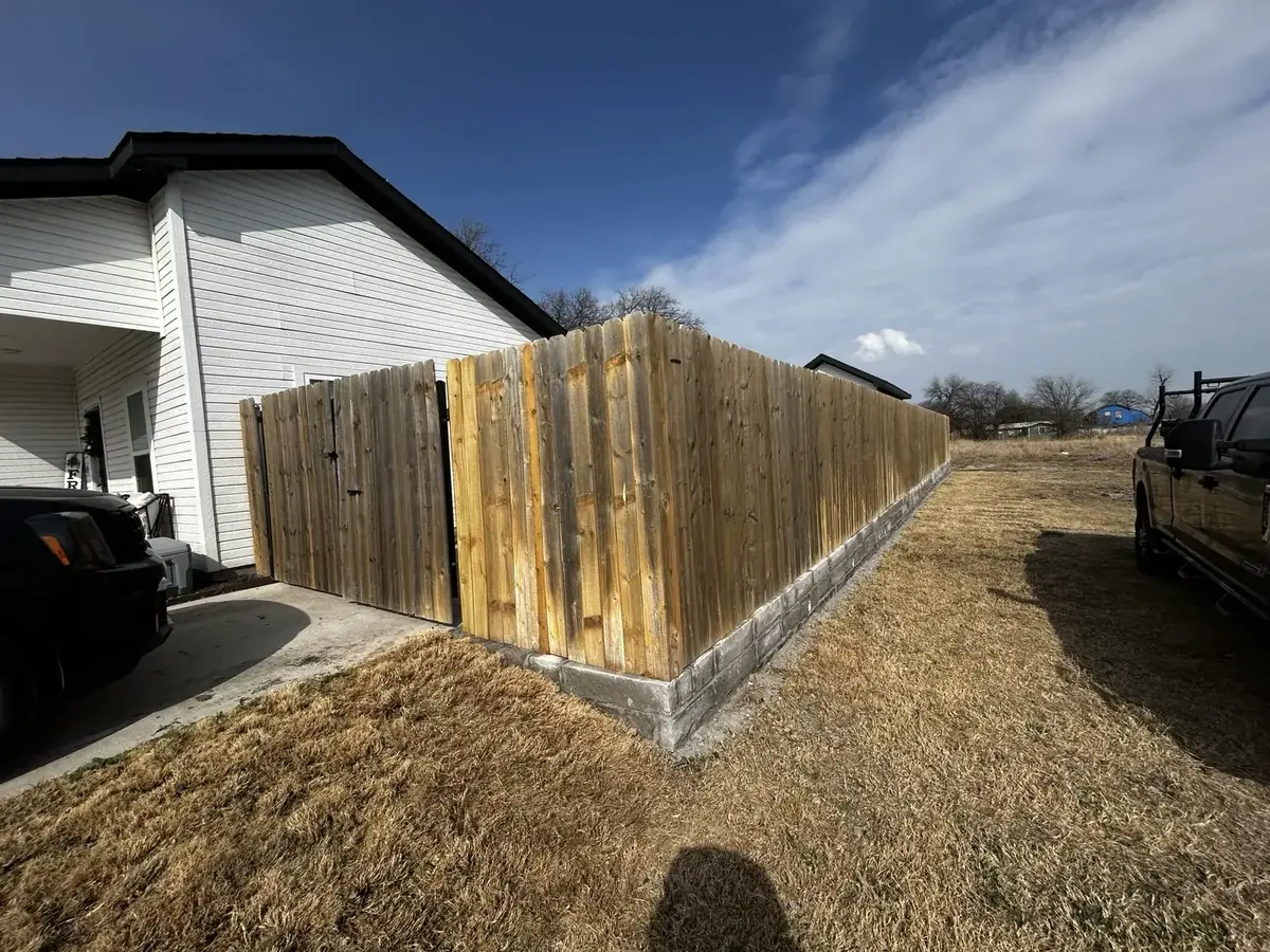 Wood fence over stone wall